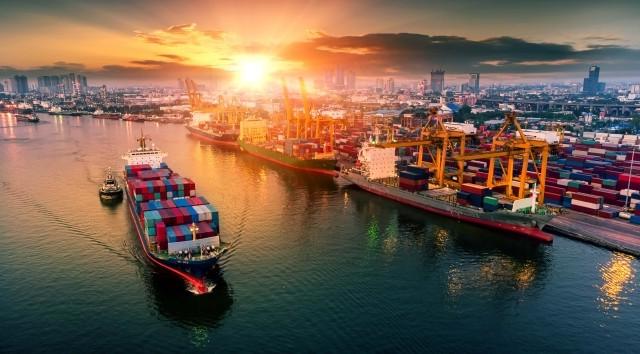 A shipping port with cargo ship in foreground